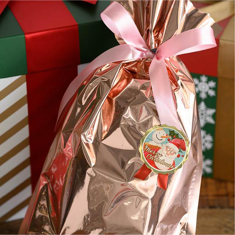 ギフト資材 XPL-1S 愉快なクリスマスリボン型シール-1(100枚) ヘッズ